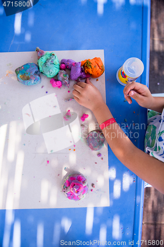 Image of kid hands Playing with Colorful Clay