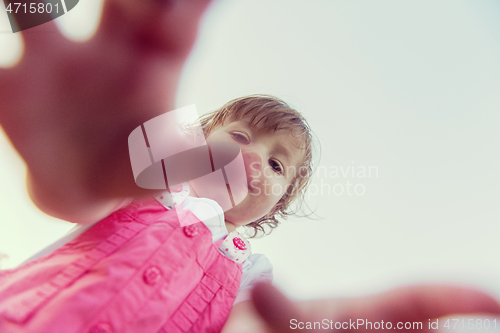 Image of little girl spending time at backyard