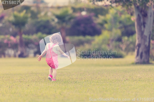 Image of little girl spending time at backyard