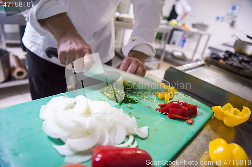 Image of Chef hands cutting fresh and delicious vegetables