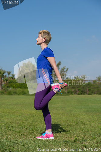 Image of female runner warming up and stretching