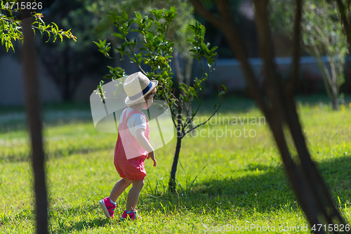 Image of little girl runing in the summer Park