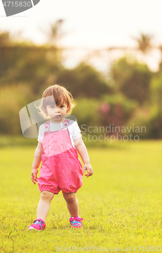 Image of little girl spending time at backyard