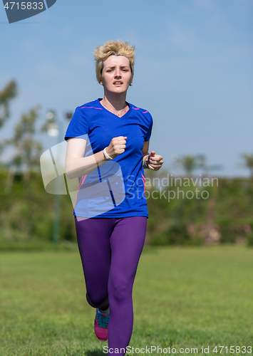 Image of young female runner training for marathon
