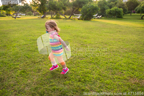 Image of little girl spending time at backyard