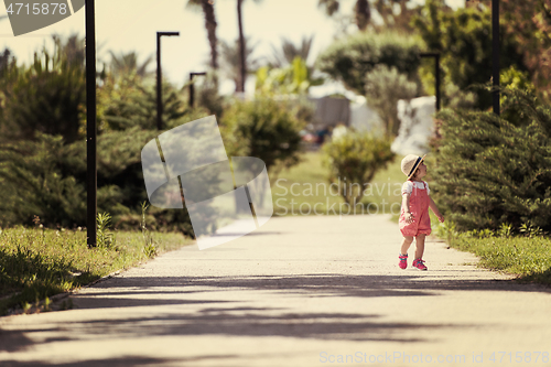 Image of little girl runing in the summer Park