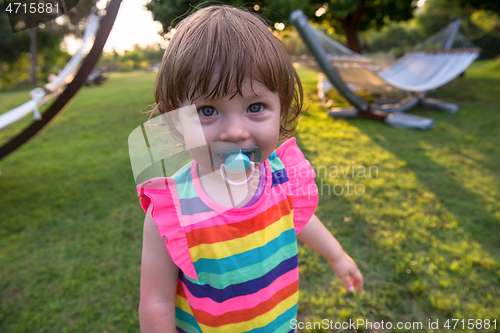 Image of little girl spending time at backyard