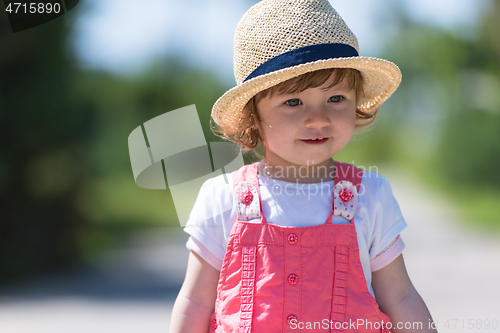 Image of little girl runing in the summer Park