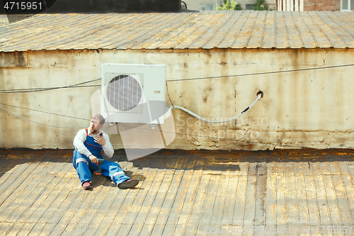 Image of HVAC technician working on a capacitor part for condensing unit