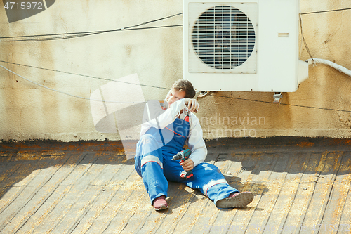 Image of HVAC technician working on a capacitor part for condensing unit