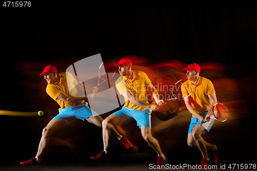 Image of One caucasian man playing tennis on black background