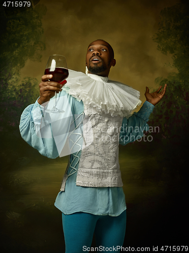 Image of Young man as a medieval knight on dark background