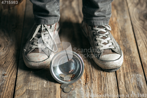 Image of Male beggar hands seeking food or money at public path way