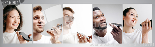 Image of Portrait of people showing blank screen mobile phone isolated over white background