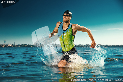 Image of Professional triathlete swimming in river\'s open water