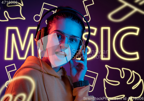 Image of Beautiful girl isolated on studio background in neon light