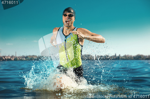 Image of Professional triathlete swimming in river\'s open water