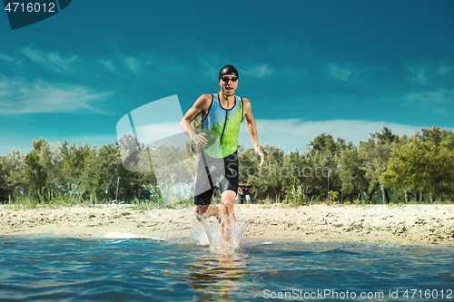 Image of Professional triathlete swimming in river\'s open water