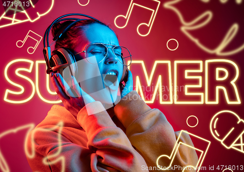 Image of Beautiful girl isolated on studio background in neon light