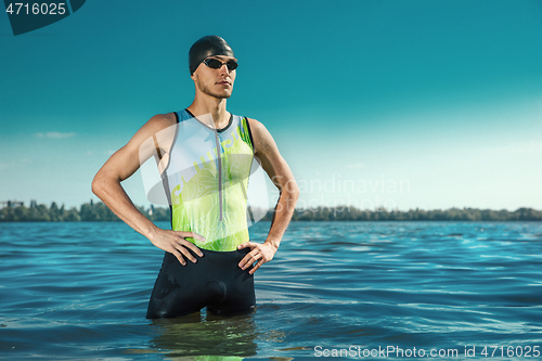 Image of Professional triathlete swimming in river\'s open water