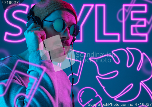 Image of Beautiful young man isolated on studio background in neon light