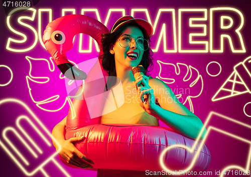 Image of Beautiful girl isolated on studio background in neon light