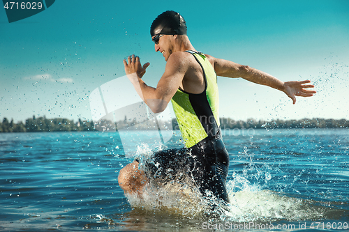 Image of Professional triathlete swimming in river\'s open water