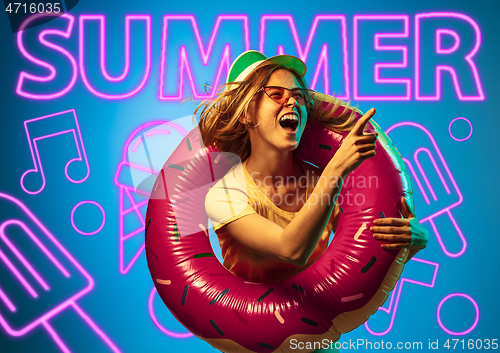 Image of Beautiful girl isolated on studio background in neon light