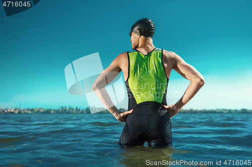 Image of Professional triathlete swimming in river\'s open water