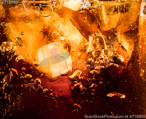 Image of Close up view of the ice cubes in dark cola background