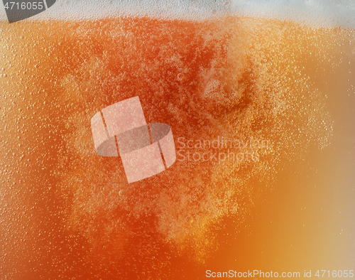 Image of Close up view of floating bubbles in unfiltered beer texture