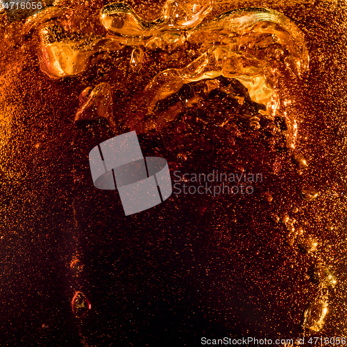 Image of Close up view of the ice cubes in dark cola background