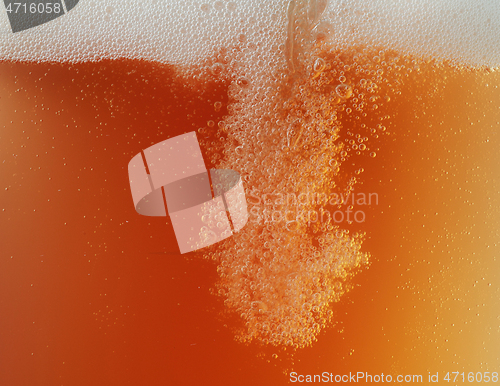 Image of Close up view of floating bubbles in unfiltered beer texture