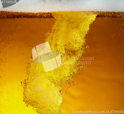 Image of Close up view of floating bubbles in light beer texture