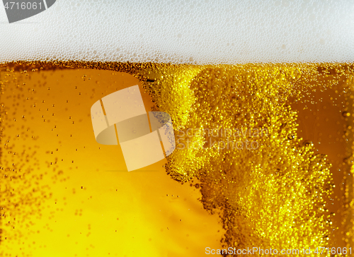 Image of Close up view of floating bubbles in light beer texture