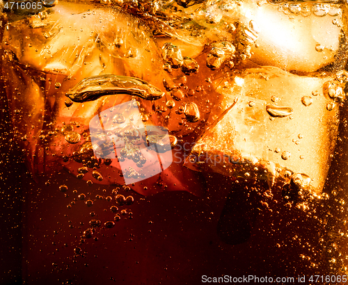 Image of Close up view of the ice cubes in dark cola background