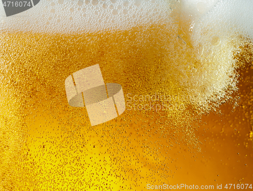 Image of Close up view of floating bubbles in light beer texture