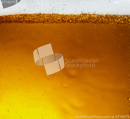 Image of Close up view of floating bubbles in light beer texture