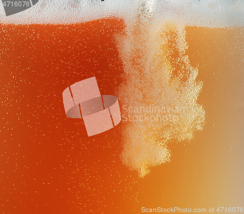 Image of Close up view of floating bubbles in unfiltered beer texture