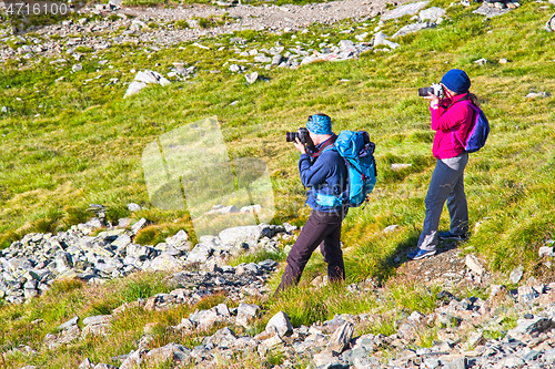 Image of Young tourists taking photo