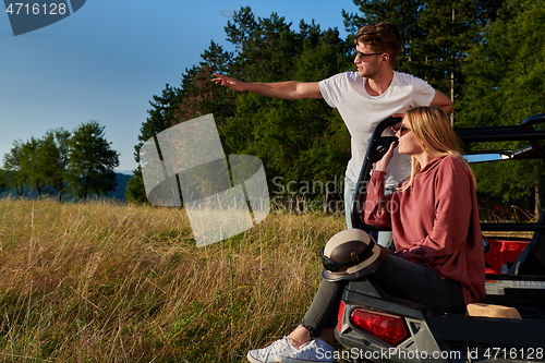 Image of couple enjoying beautiful sunny day while driving a off road buggy