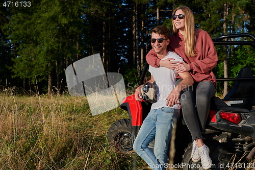 Image of couple enjoying beautiful sunny day while driving a off road buggy