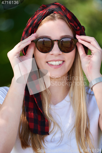 Image of portrait of beautiful, emotional, young woman in sunglasses.