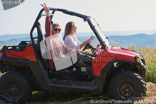 Image of girls enjoying a beautiful sunny day while driving an off-road car