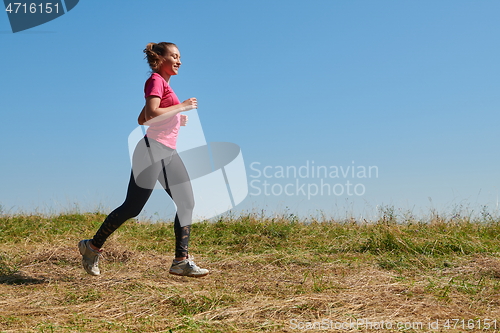 Image of woman enjoying in a healthy lifestyle while jogging