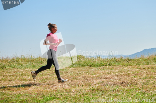 Image of woman enjoying in a healthy lifestyle while jogging