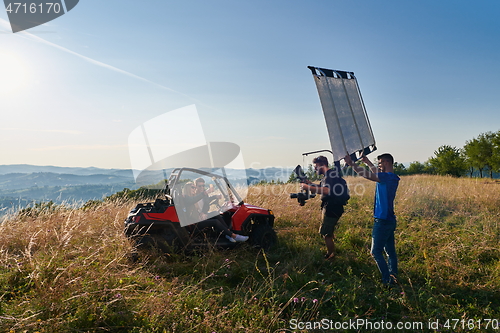 Image of cameraman recording a young couple enjoying a buggy car ride up a mountain