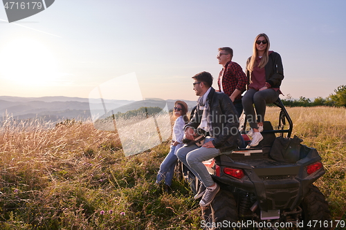 Image of group young happy people enjoying beautiful sunny day while driving a off road buggy car