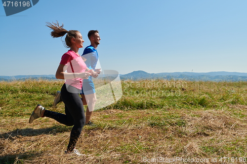 Image of couple jogging in a healthy lifestyle on a fresh mountain air