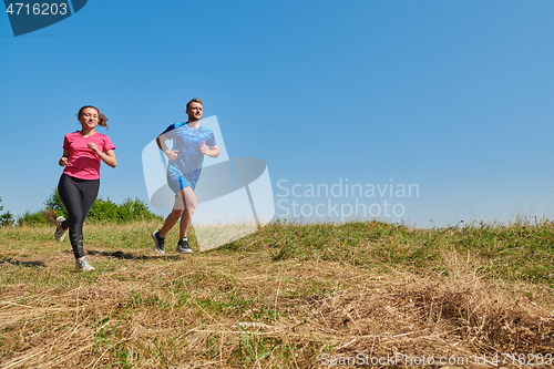 Image of couple jogging in a healthy lifestyle on a fresh mountain air